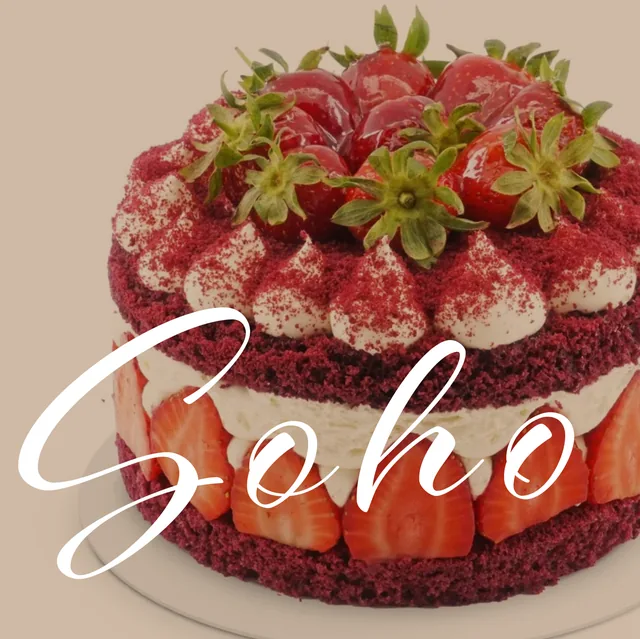 A white handwritten Soho over a red velvet cake with strawberries